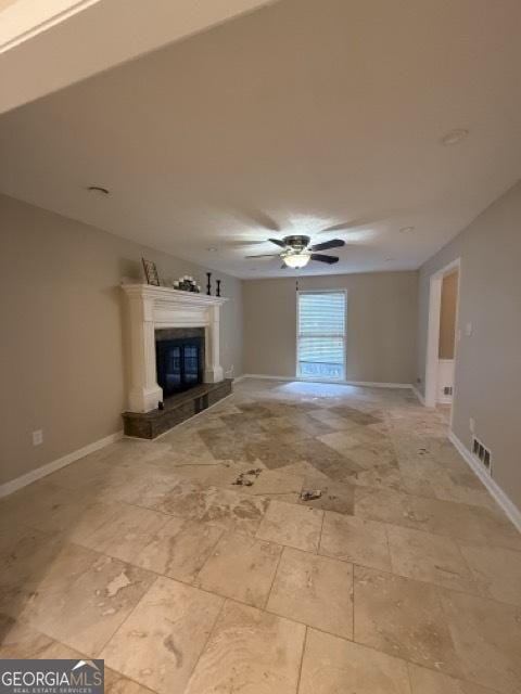 unfurnished living room featuring ceiling fan