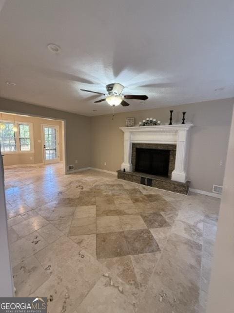 unfurnished living room with ceiling fan