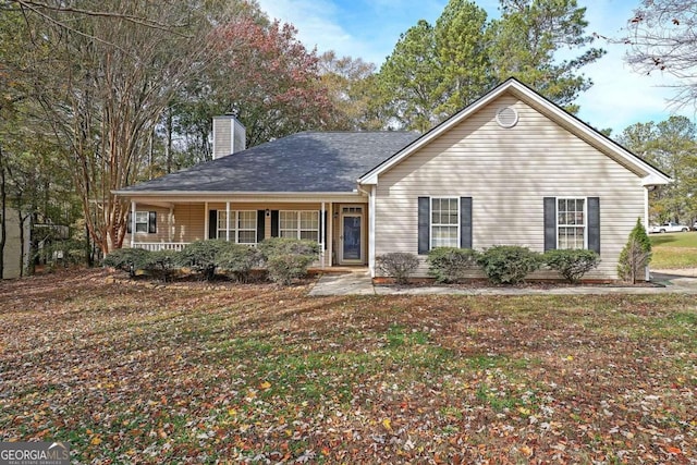 view of front facade with covered porch and a front yard