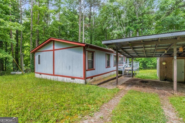 view of side of home featuring a storage shed and a wooden deck