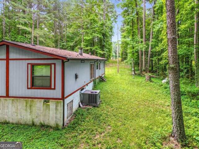 view of side of home featuring central AC