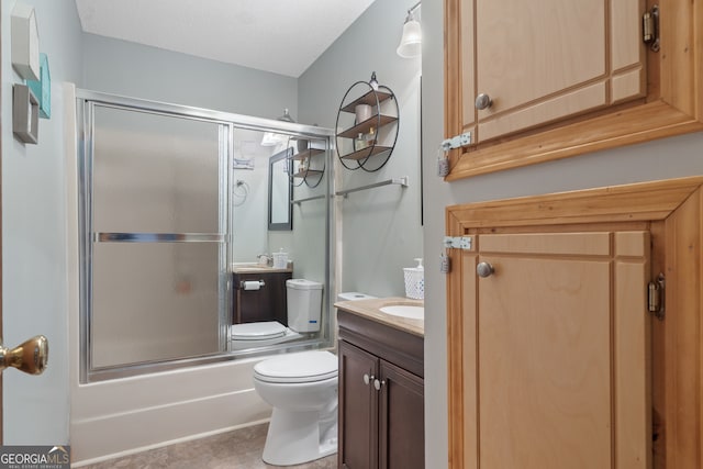 full bathroom with vanity, toilet, and shower / bath combination with glass door