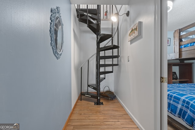 stairway with hardwood / wood-style floors