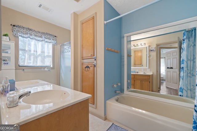 bathroom with vanity and a textured ceiling