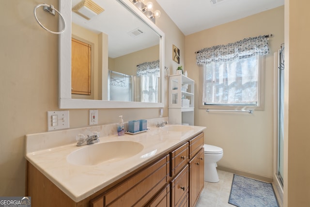 bathroom featuring a shower, vanity, and toilet