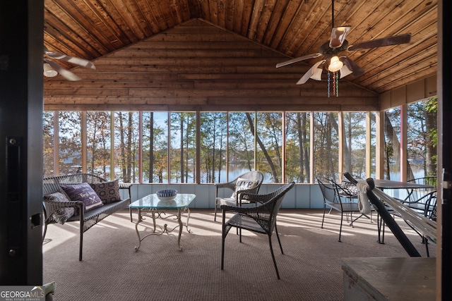 unfurnished sunroom featuring ceiling fan, a water view, and wood ceiling