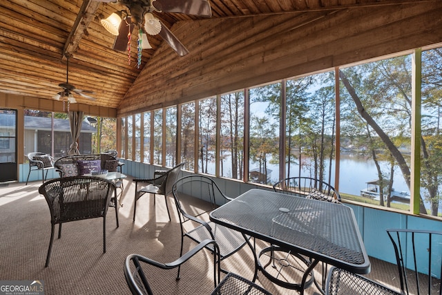 sunroom with ceiling fan, a water view, wooden ceiling, and vaulted ceiling