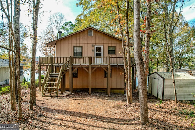 back of property with a storage unit and a deck