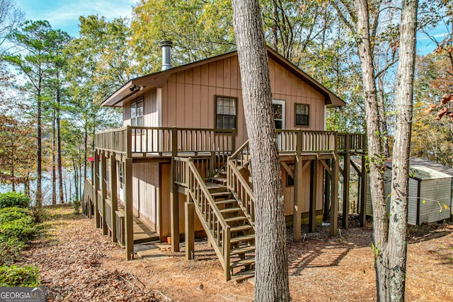 back of property with a shed and a deck