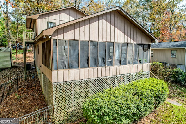 view of home's exterior with a sunroom