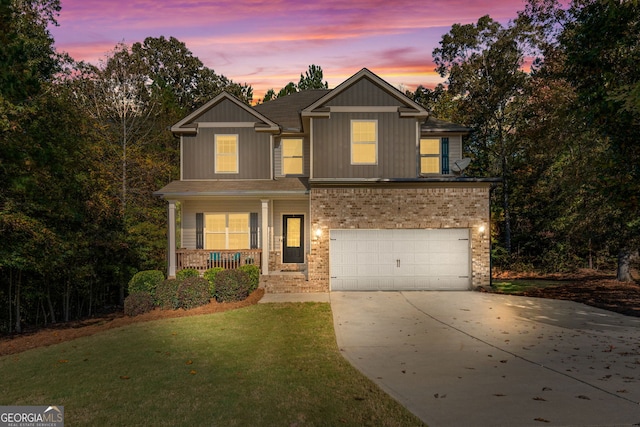 craftsman inspired home with a porch, a garage, and a yard