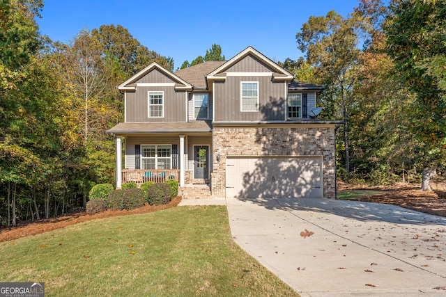 view of front of house featuring a porch, a garage, and a front yard