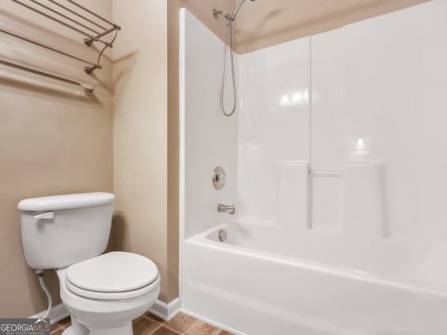 bathroom with tile patterned floors, toilet, and bathtub / shower combination