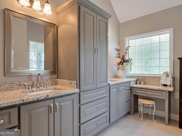 bathroom featuring vanity and lofted ceiling