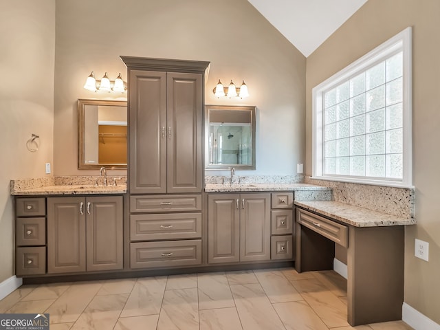 bathroom featuring vanity and vaulted ceiling