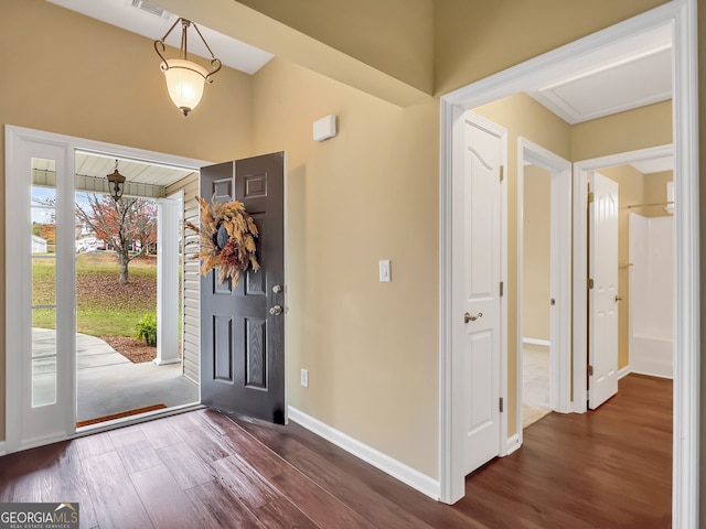 entryway with dark hardwood / wood-style flooring