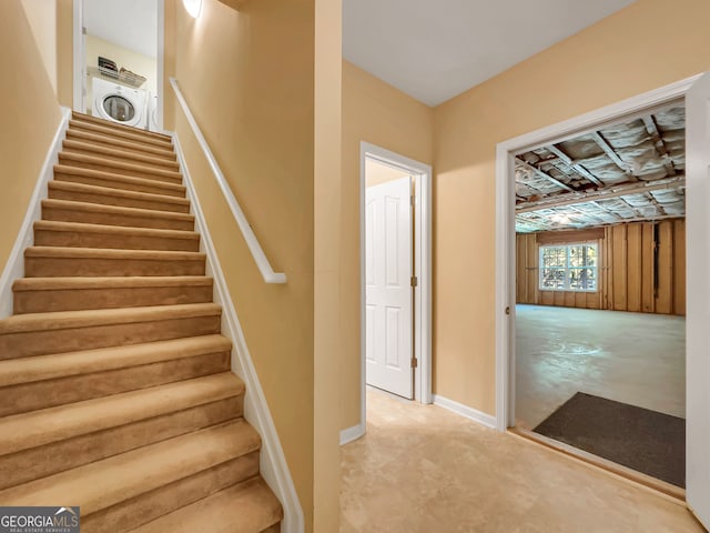 stairway featuring washer / dryer