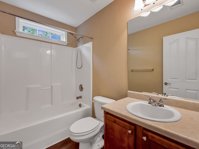 full bathroom featuring bathing tub / shower combination, hardwood / wood-style flooring, vanity, and toilet