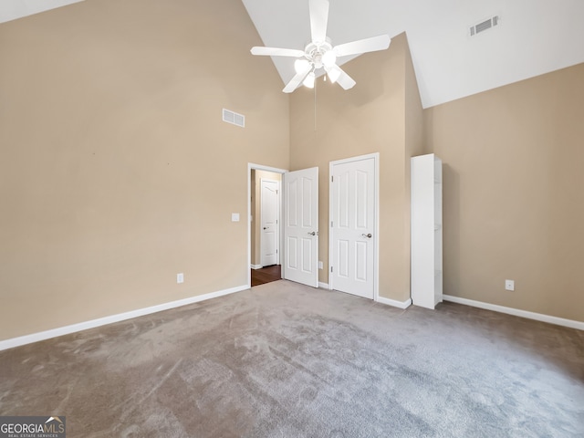 unfurnished bedroom featuring carpet, high vaulted ceiling, and ceiling fan