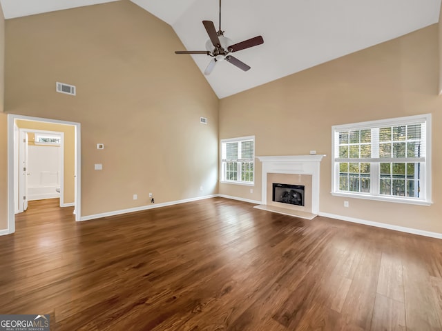 unfurnished living room featuring wood-type flooring, high vaulted ceiling, and ceiling fan