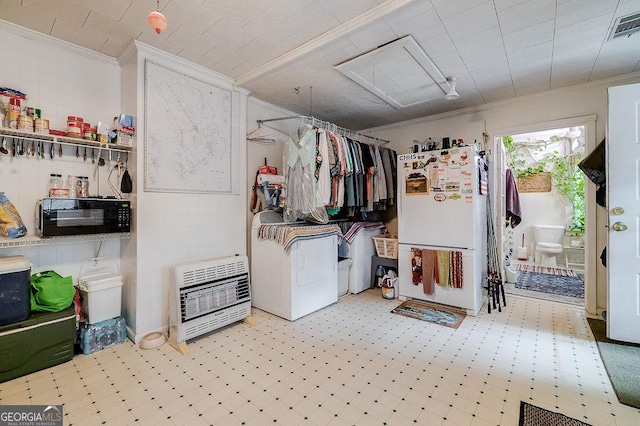 clothes washing area featuring crown molding and heating unit