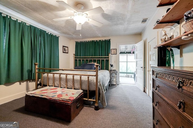 bedroom with ceiling fan, carpet, and a textured ceiling