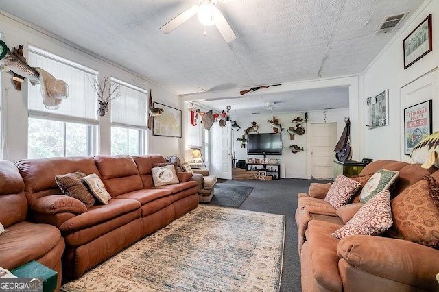 carpeted living room with a textured ceiling and ceiling fan