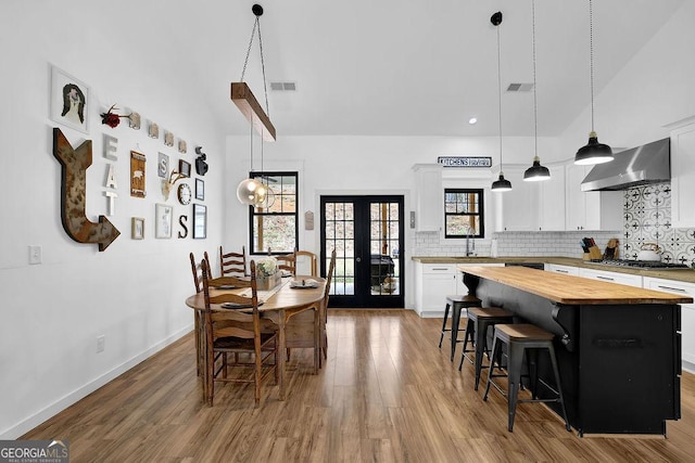 dining area featuring hardwood / wood-style floors, french doors, and a healthy amount of sunlight