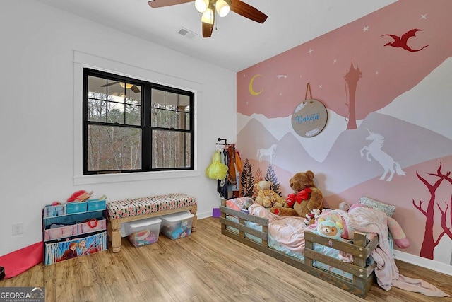 recreation room with ceiling fan and hardwood / wood-style floors