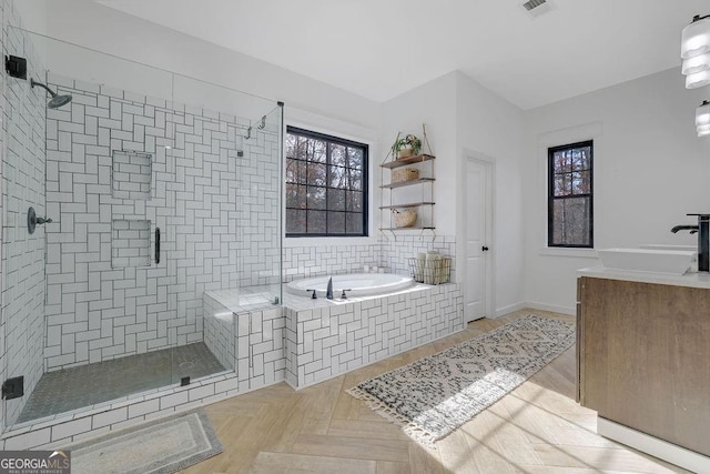 bathroom featuring parquet flooring, vanity, and independent shower and bath