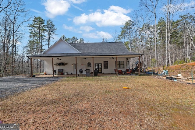 back of property featuring a yard and ceiling fan