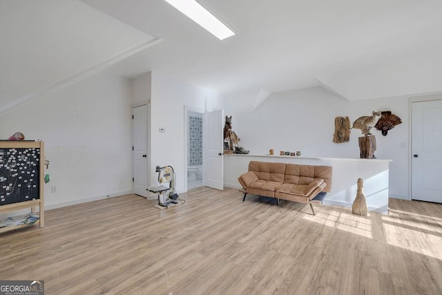 sitting room featuring light hardwood / wood-style floors and vaulted ceiling