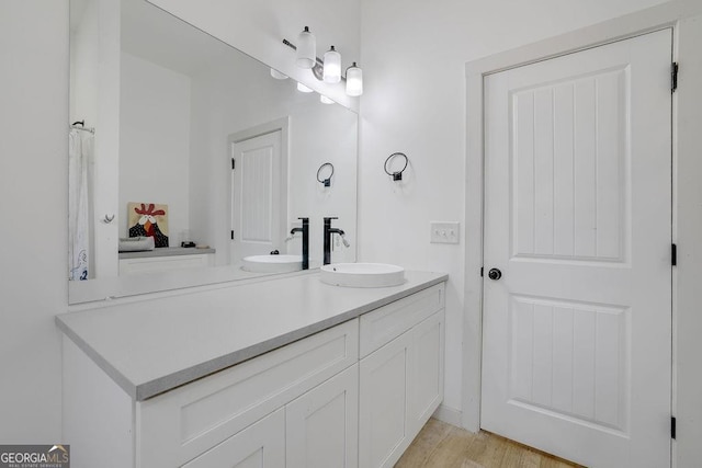 bathroom with vanity and hardwood / wood-style floors