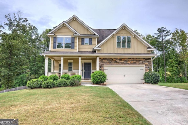 craftsman inspired home with a garage, a porch, and a front yard