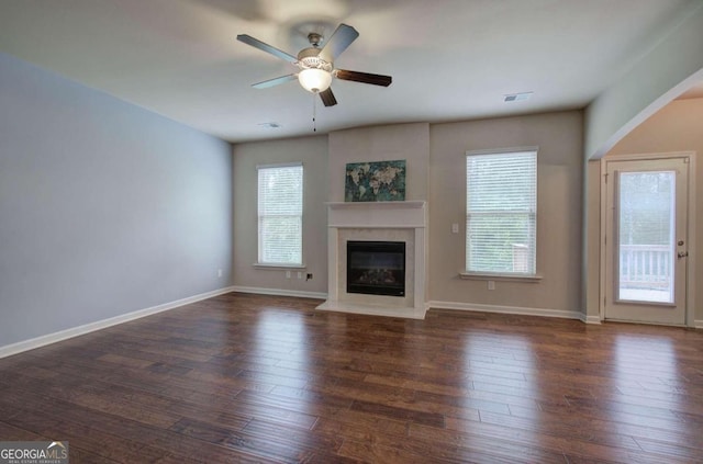 unfurnished living room with ceiling fan and dark hardwood / wood-style flooring