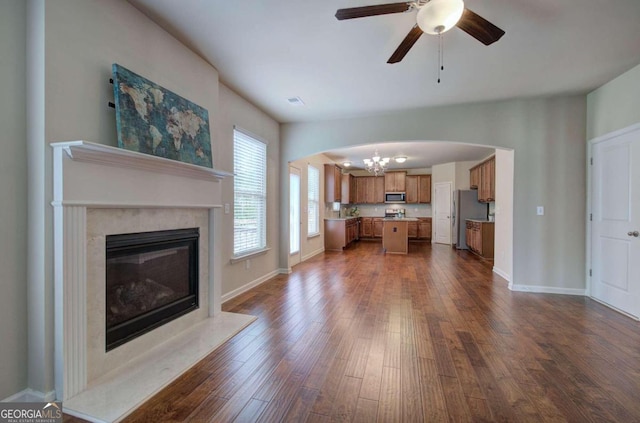 unfurnished living room with ceiling fan, dark hardwood / wood-style flooring, and a high end fireplace