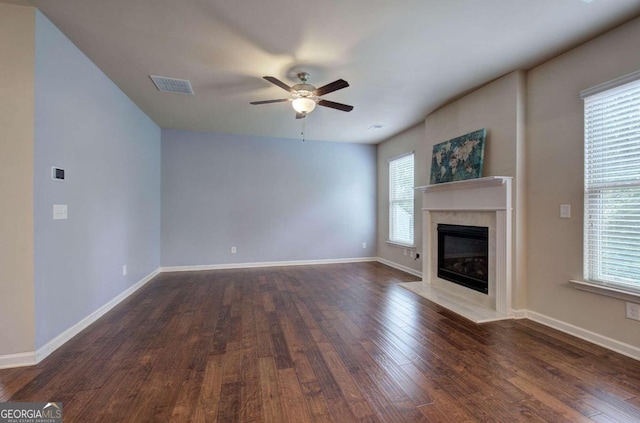 unfurnished living room featuring dark hardwood / wood-style flooring and ceiling fan