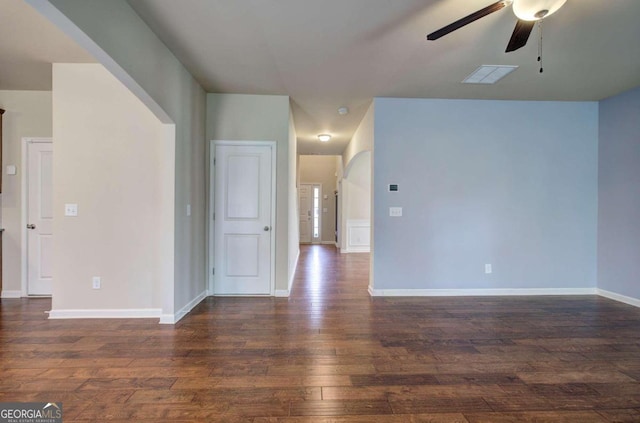 empty room featuring ceiling fan and dark wood-type flooring