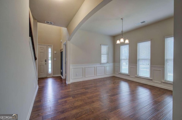 interior space with dark hardwood / wood-style floors and an inviting chandelier