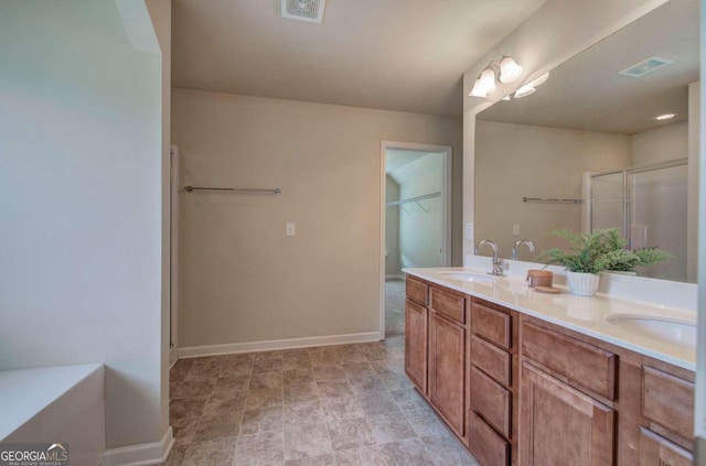 bathroom with vanity and a shower with door