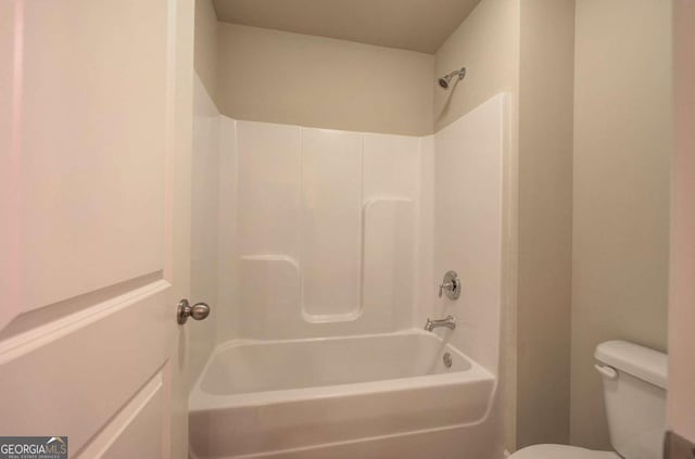 bathroom featuring shower / bath combination and toilet