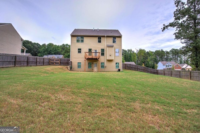 back of property with a balcony and a lawn