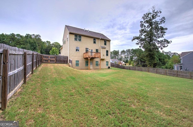 rear view of house featuring a yard