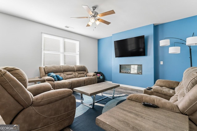 living room featuring ceiling fan and hardwood / wood-style flooring