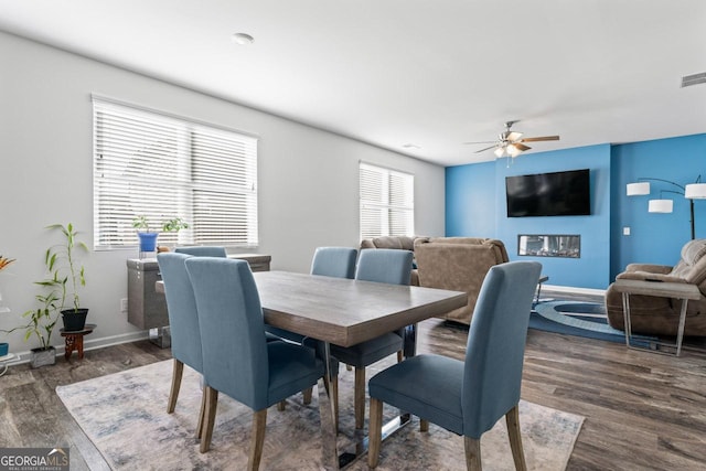 dining room with dark wood-type flooring and ceiling fan