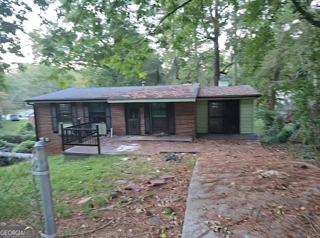 rear view of property featuring a porch