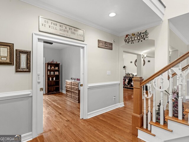 mudroom featuring hardwood / wood-style flooring and crown molding