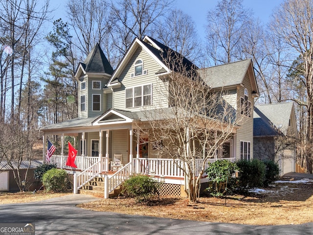 victorian home with driveway and a porch