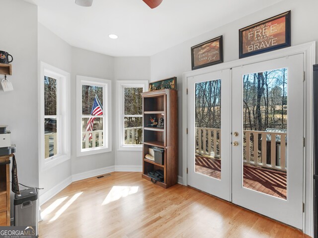 interior space featuring a wealth of natural light, light hardwood / wood-style floors, french doors, and ceiling fan