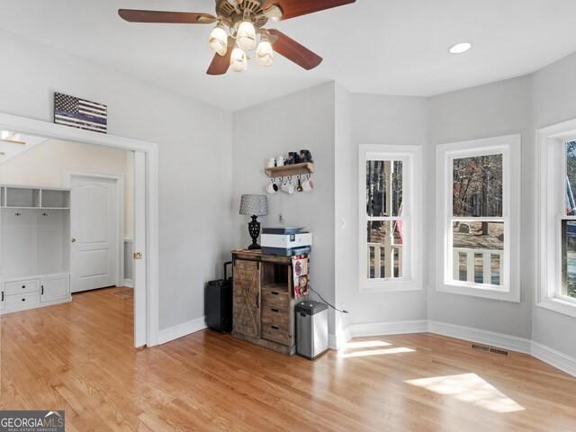 doorway with french doors, ceiling fan, and light hardwood / wood-style floors